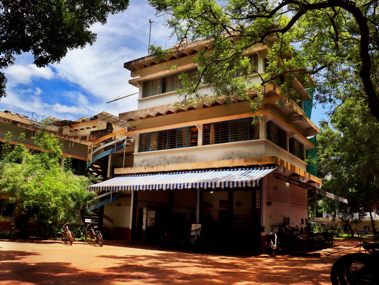 The Kinisi Cowork building at CSR Campus, Auroshilpam, Auroville, seen from the courtyard.